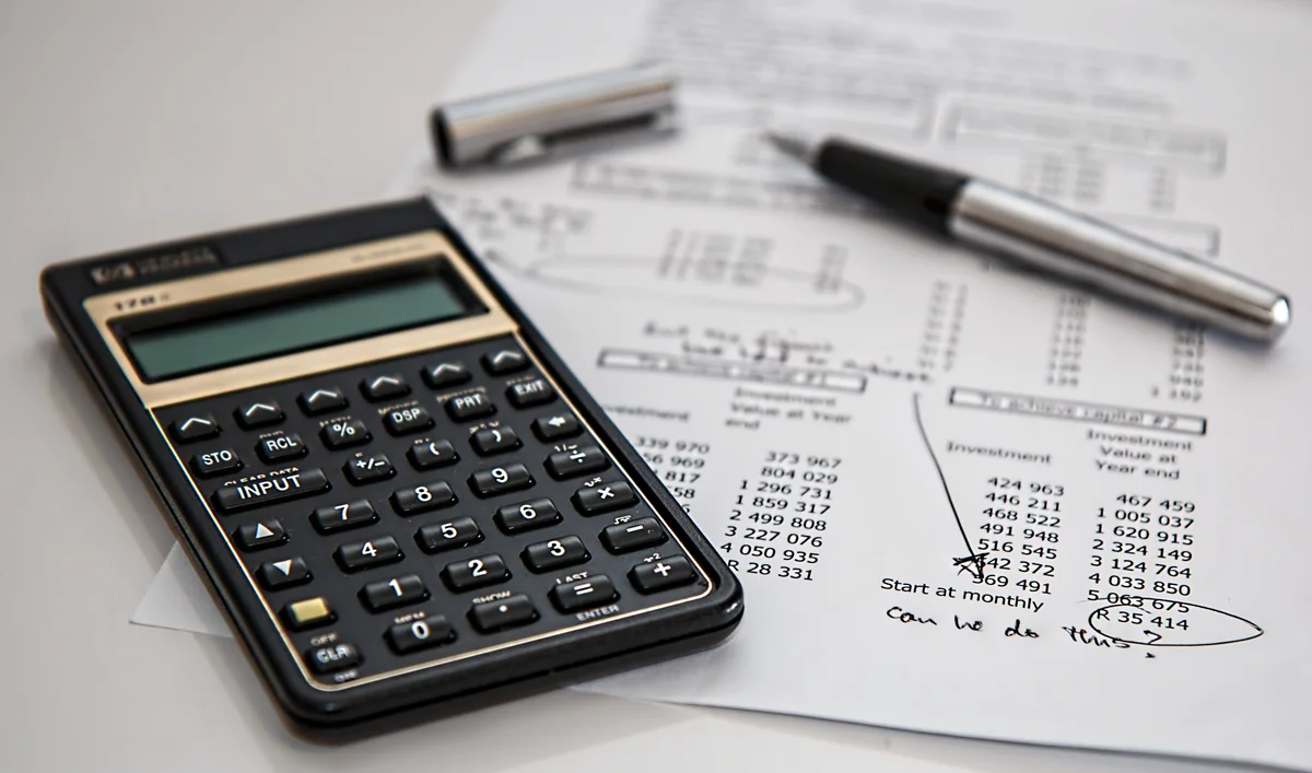Calculator and financial paperwork, photographed in 2014.